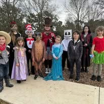 students in the garden in their book week character costuems