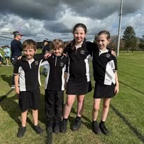 four students in sports uniform