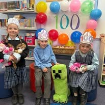 three students holding their stuffed toys in celebration of their 100 days of learning