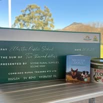 a large check, a book and a tub of fertiliser