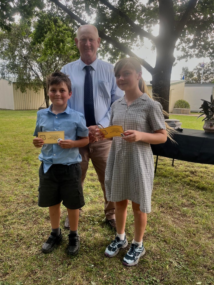 Children standing with council member reciving certificates