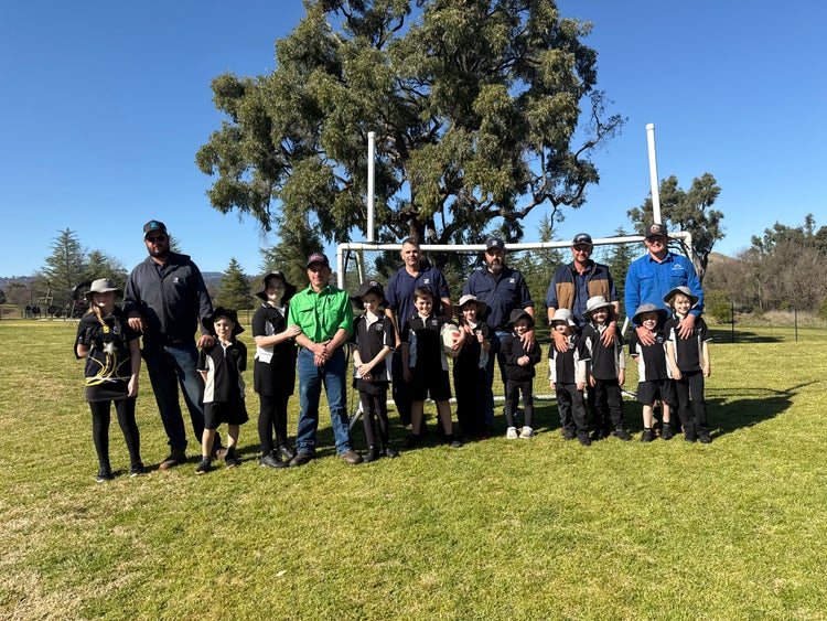 Children and their dads standing in front of the soccer goals after their breakfast at the fathers day breakfast
